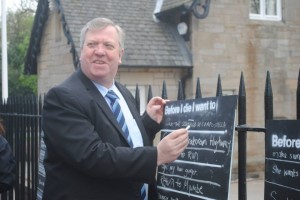 Michael McMahon writes on BiD wall outside parliament as part of awareness week in May